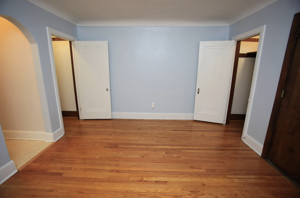 a empty room with blue walls and wooden floors